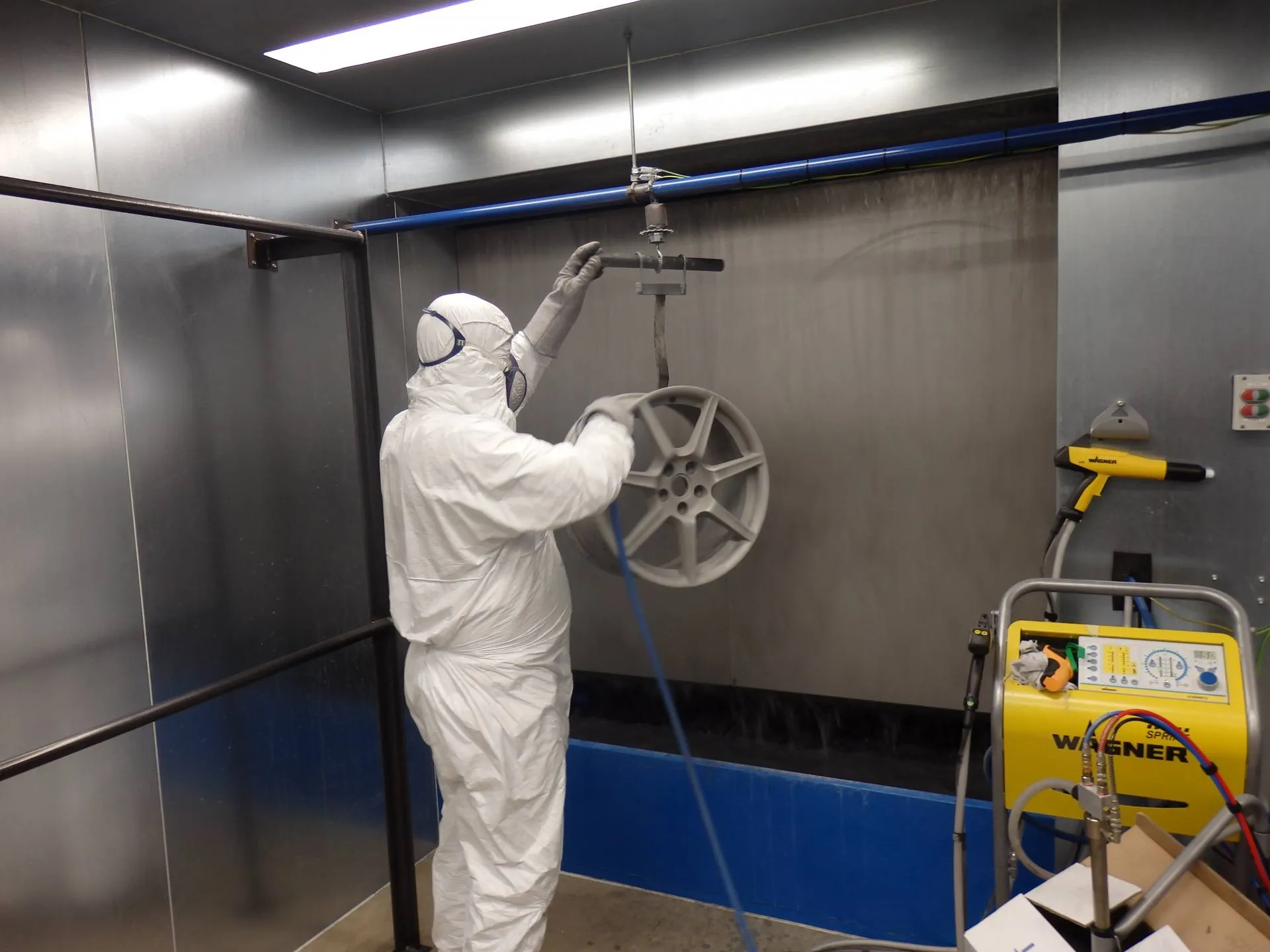 Direct Finish technician powder coating an alloy wheel at the York repair centre
